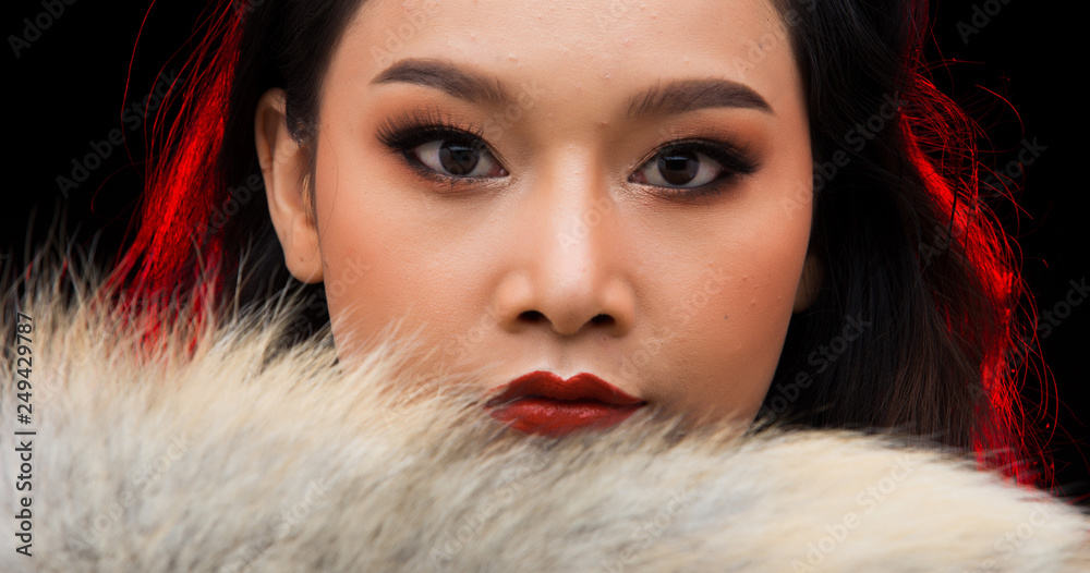 Beautiful Young Asian black hair fur woman in fire red screen, high glitter fashion make up, studio lighting hot smoke burgundy background copy space, concept futuristic in heat empty space Beautiful Young Asian black hair fur woman in fire red screen, high glitter fashion make up, studio lighting hot smoke burgundy background copy space, concept futuristic in heat empty space
