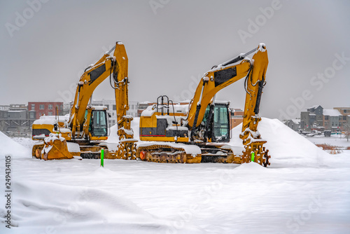 Snowy excavators during winter in Daybreak Utah