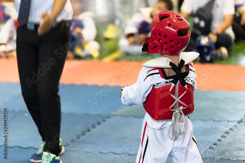 Moment of Taekwondo Kids in the stadiums waiting for the signal. Athlete to strike an opponent during the tournament taekwondo kids. photo