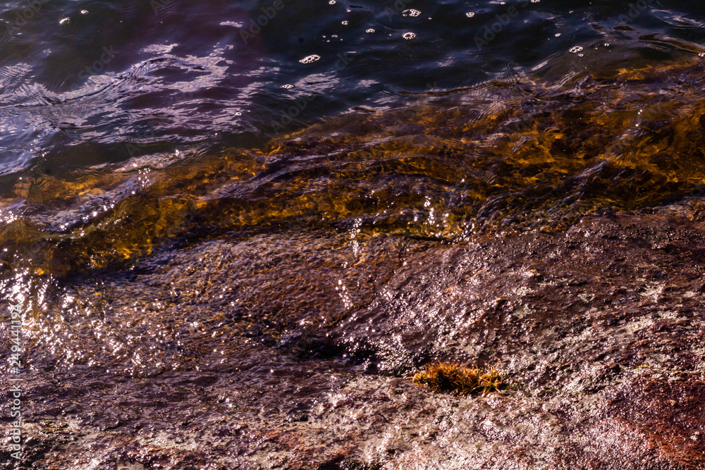 Water lapping onto a rocky lake-shore. Water lapping onto a rocky lake-shore.