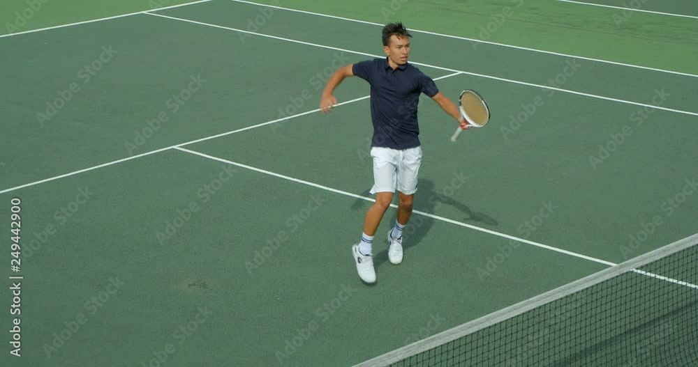 A Tennis Player runs across court plays a great shot and celebrates. A Tennis Player runs across court plays a great shot and celebrates.