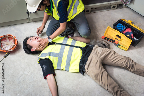 Check Response and pulse, Life-saving and rescue methods. Accident at work of electrician job or Maintenance worker in the control room of factory.