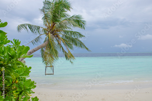 The landscape the island of Biyadhoo Maldives the beach with white sand and a swing over the ocean