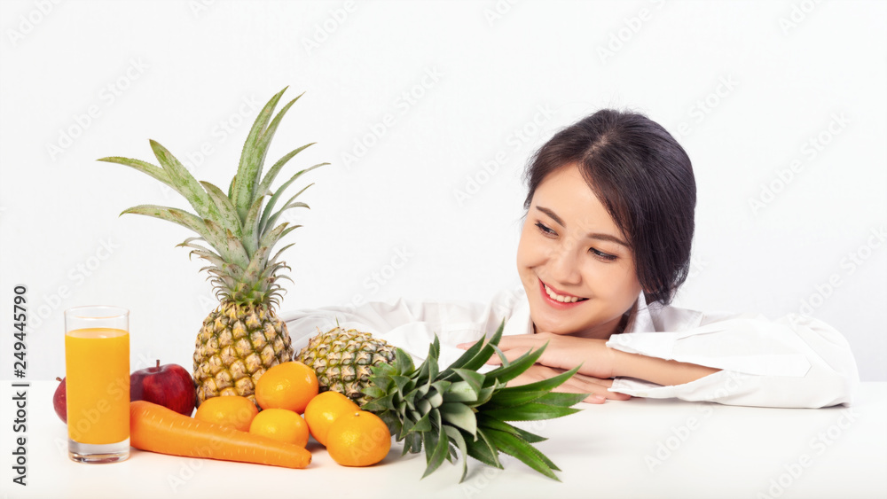 Asian young woman happiness and looking to Fresh fruit and Orange juice on table. Asian young woman happiness and looking to Fresh fruit and Orange juice on table.