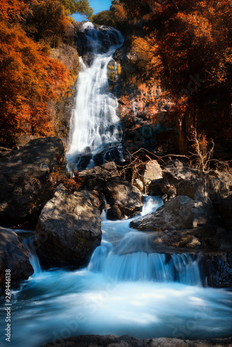 Fototapeta Naklejka Na Ścianę i Meble -  Beautiful waterfall in spring forest with sunlight. Traveling in the spring forest and new discovery waterfalls.