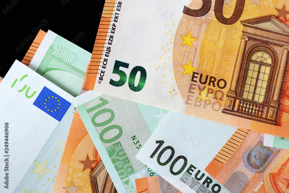 One Hundred and Fifty euro banknotes on a dark background close up One Hundred and Fifty euro banknotes on a dark background close up