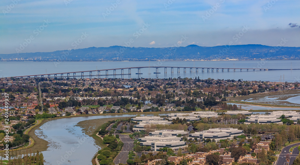 Aerial view from an airplane of San Mateo Hayward bridge across the San Francisco Bay and Foster City in  San Mateo County, California