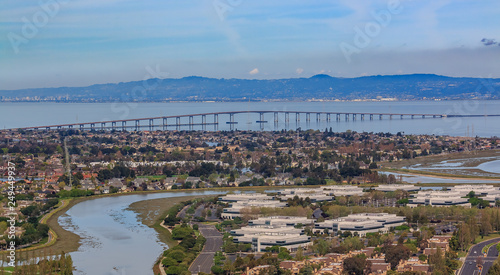Aerial view from an airplane of San Mateo Hayward bridge across the San Francisco Bay and Foster City in  San Mateo County, California photo