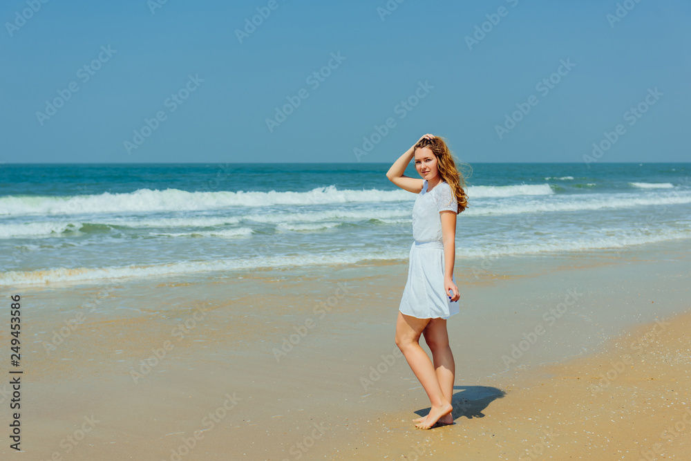 Beautiful Girl in White Dress Enjoy and Relax on The Beach. Travel and Vacation. Beautiful Girl in White Dress Enjoy and Relax on The Beach. Travel and Vacation.