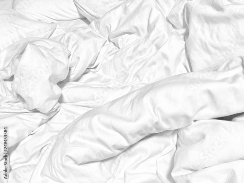 Wrinkle white soft blanket on the bed after wake up in the morning.