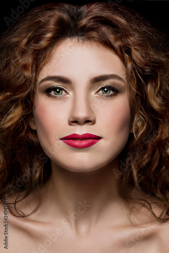 Beautiful portrait of curly redhead woman with makeup