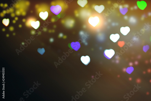 Multicolored bokeh on black background. Heart shape. Love Concept, Valentine's Day. Can be used as a background or wallpaper © Alex