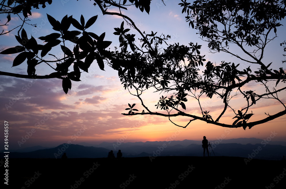 silhouette of people at the top of hill