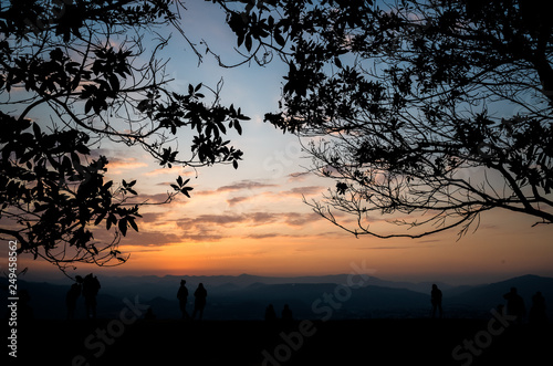 silhouette of people at the top of hill