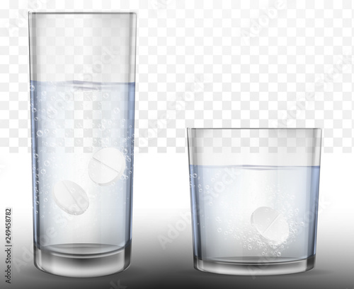 Realistic effervescent tablets in glass of water.