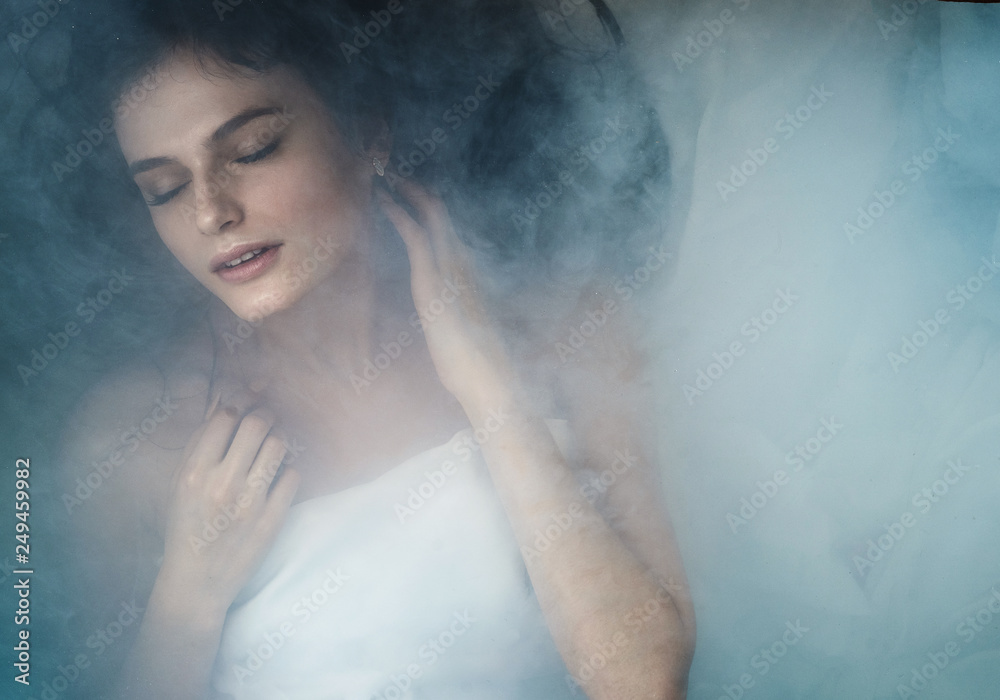 close portrait of a girl in smoke lying on her back