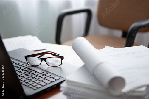 office desk a stack of computer paper reports work forms