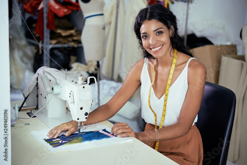 Seamstress working on sewing machine photo