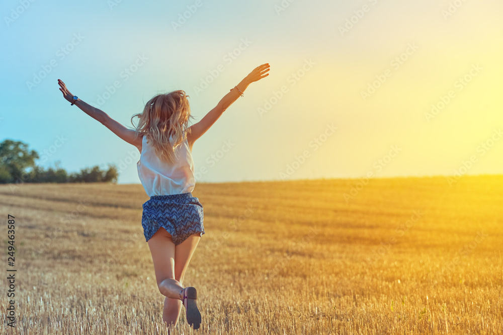 Cute young woman jumping in a wheat field. Cute young woman jumping in a wheat field.