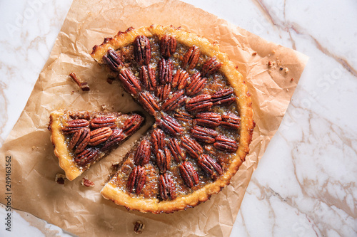 Parchment with tasty pecan pie on light table