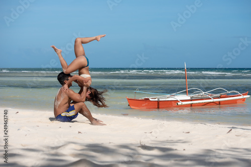 Fototapeta Naklejka Na Ścianę i Meble -  Filipino couple at the beach and yoga poses