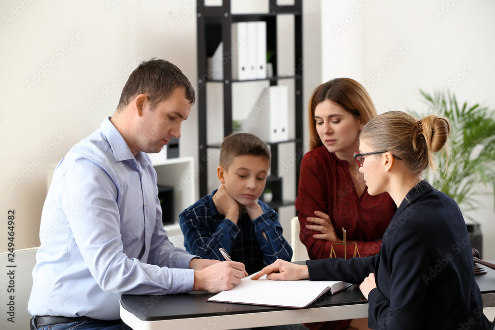 Divorced parents with their son visiting lawyer. Concept of child support Divorced parents with their son visiting lawyer. Concept of child support
