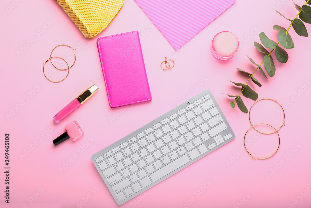 Composition with keyboard, beauty accessories and cosmetics on color background Composition with keyboard, beauty accessories and cosmetics on color background