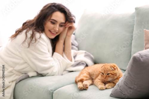 Young woman with cute funny cat at home