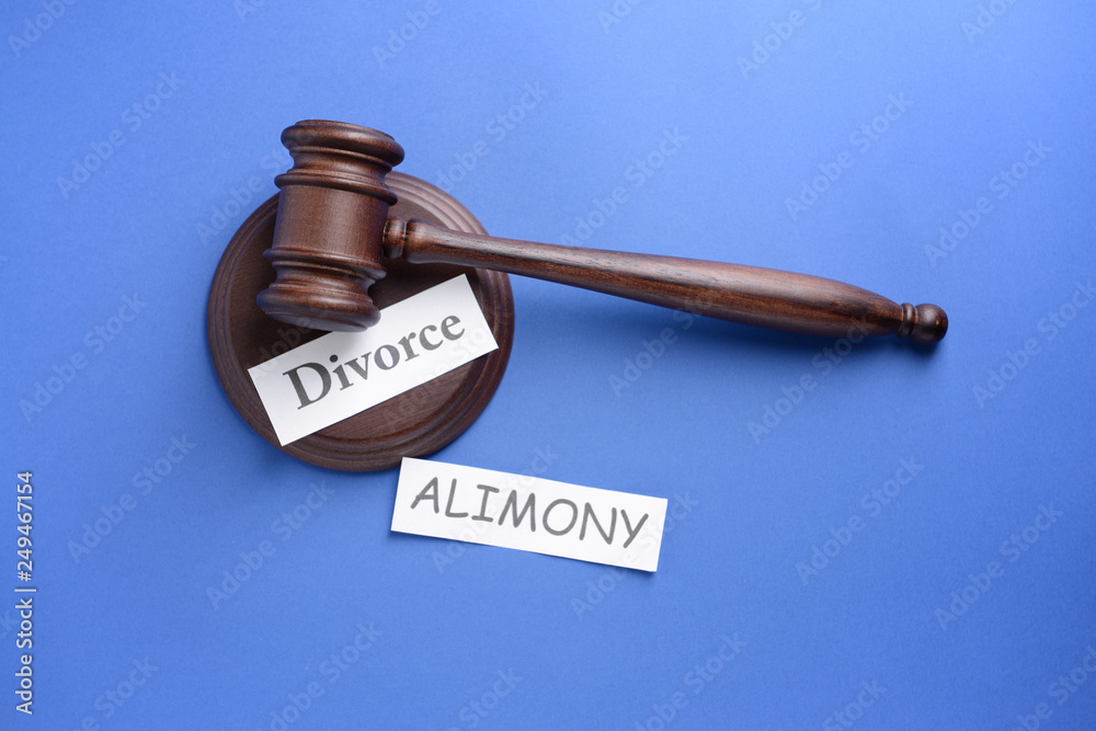 Words ALIMONY and DIVORCE with judge gavel on color background Words ALIMONY and DIVORCE with judge gavel on color background