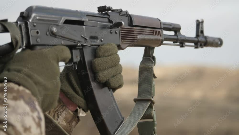 Officer shooting from automated rifle AK 74M in autumn in a firing range in slo-mo Officer shooting from automated rifle AK 74M in autumn in a firing range in slo-mo