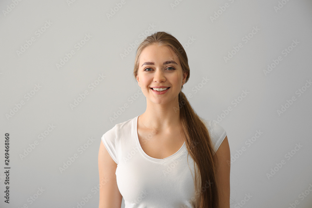 Happy young woman on light background Happy young woman on light background