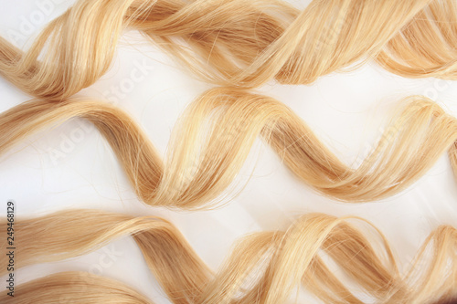 Curls curled on the Curling iron  isolated on white background. strand of blonde hair  hair care