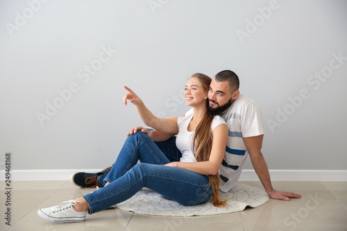 Young couple sitting on flo...