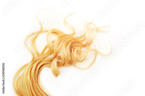 Golden Curls hair isolated on white background. strand of Blonde or red hair, hair care