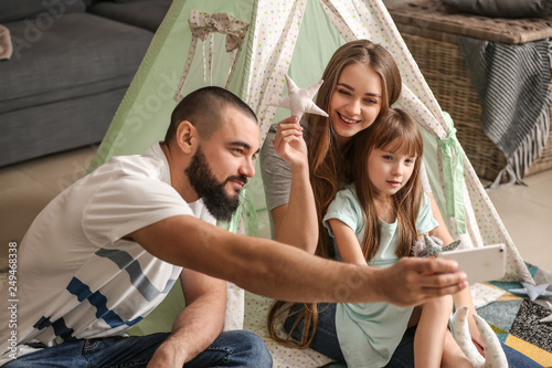 Happy family taking selfie at home