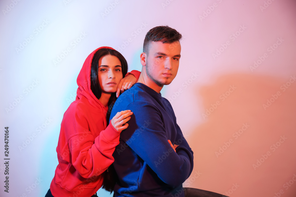 Toned portrait of stylish young couple on light background Toned portrait of stylish young couple on light background