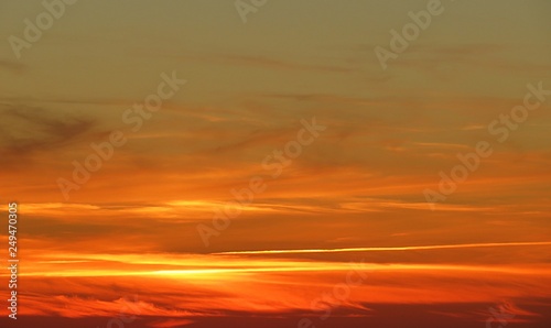 Beautiful fiery orange sunset background in the sky