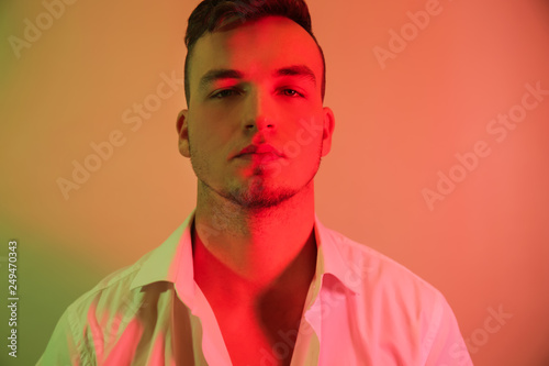 Toned portrait of handsome young man on color background