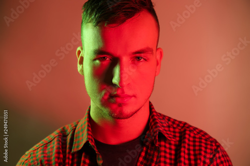 Toned portrait of handsome young man on color background