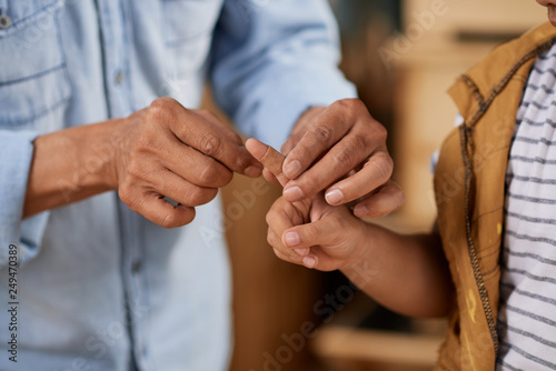 Applying band-aid on finger
