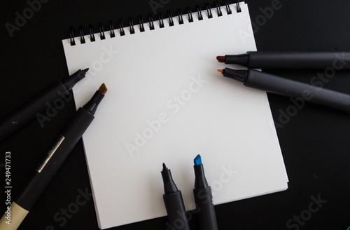 Empty paper blank, empty note with six markers, black background, open markers
