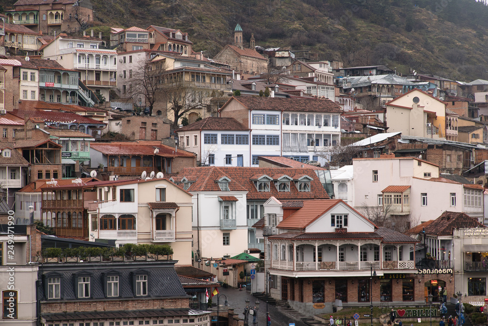 Streets and houses in Tbilisi the day. Old town.  georgia 2019. people, cars, hills, old beautiful buildings located on the hill and near the river