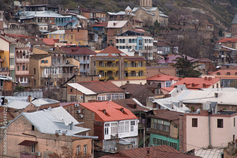 Streets and houses in Tbilisi the day. Old town.  georgia 2019. people, cars, hills, old beautiful buildings located on the hill and near the river