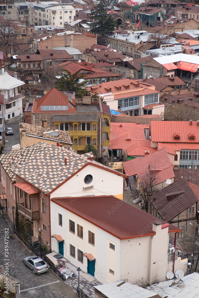 Streets and houses in Tbilisi the day. Old town. georgia 2019. people, cars, hills, old beautiful buildings located on the hill and near the river Streets and houses in Tbilisi the day. Old town. georgia 2019. people, cars, hills, old beautiful buildings located on the hill and near the river
