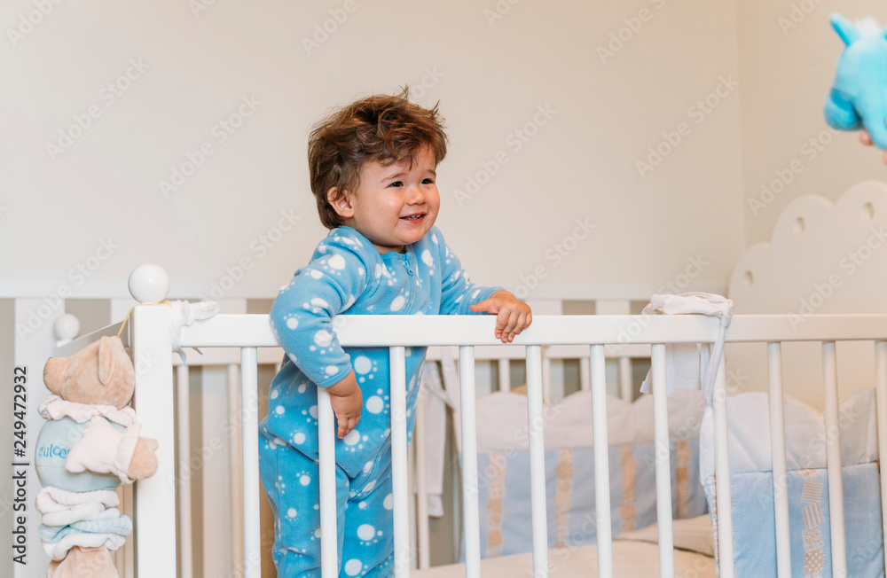 Little kid playing in bed Little kid playing in bed