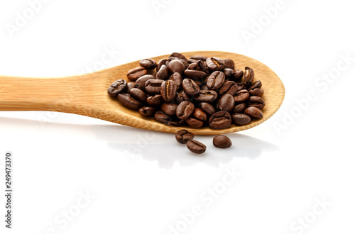 Coffee beans in spoon. Roasted coffee beans. On a white background isolated.