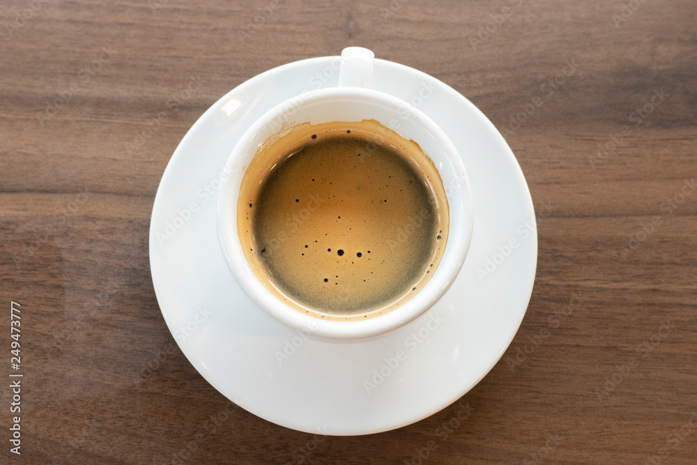 Hot coffee on wood background.