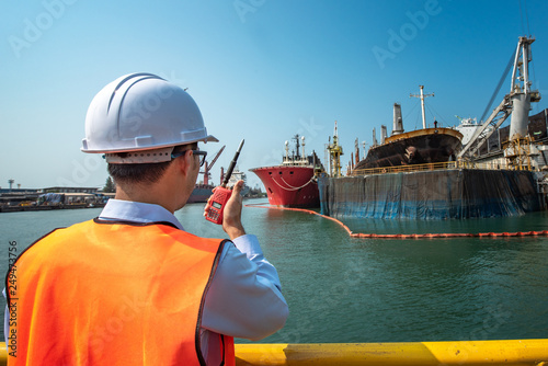 harbor master port control or engineering in command the ship to takes berthing to alongside the terminal docking, the ship securing safe floating dock yard, dry dock alongside for repairing photo