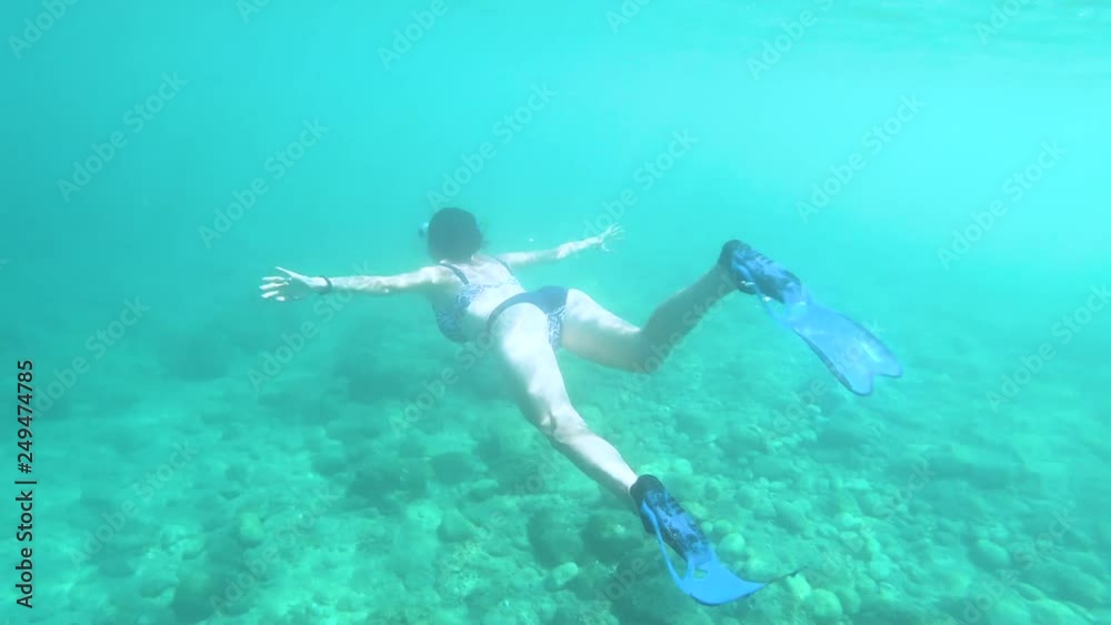 Underwater view of sexy girl in bikini snorkeling in tropical sea water Underwater view of sexy girl in bikini snorkeling in tropical sea water