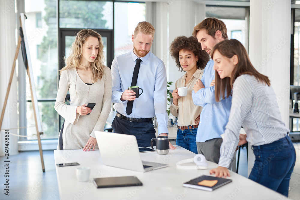 Fototapeta premium Small group of business people standing at office and solving problem at meeting. Multi cultural group.